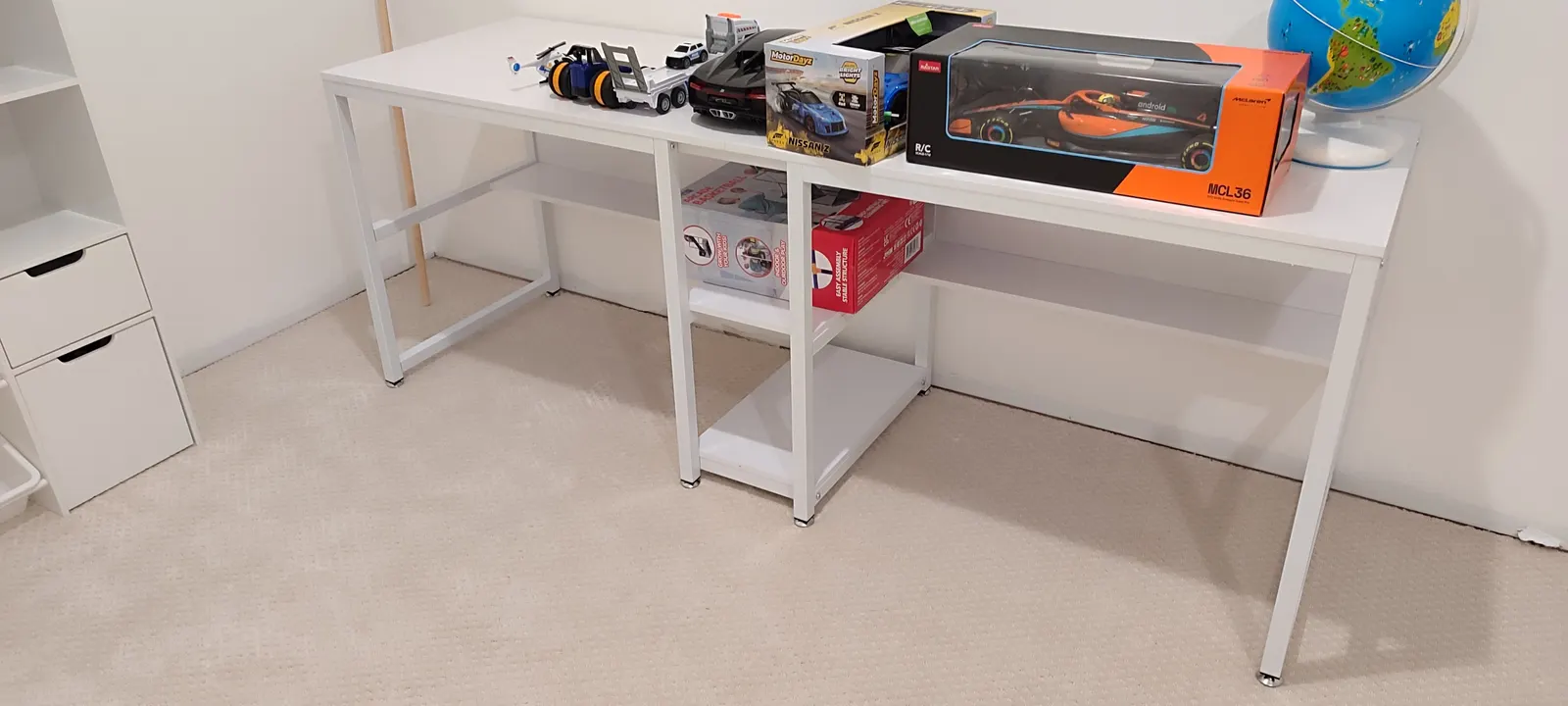 White playroom worktable with open shelving