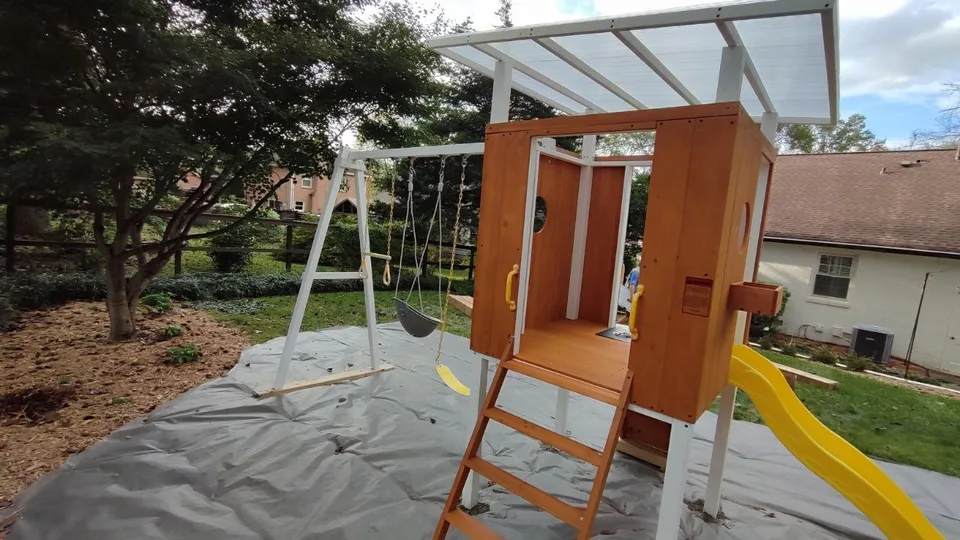 Children's playset after assembly, showing the clubhouse and swing structure.