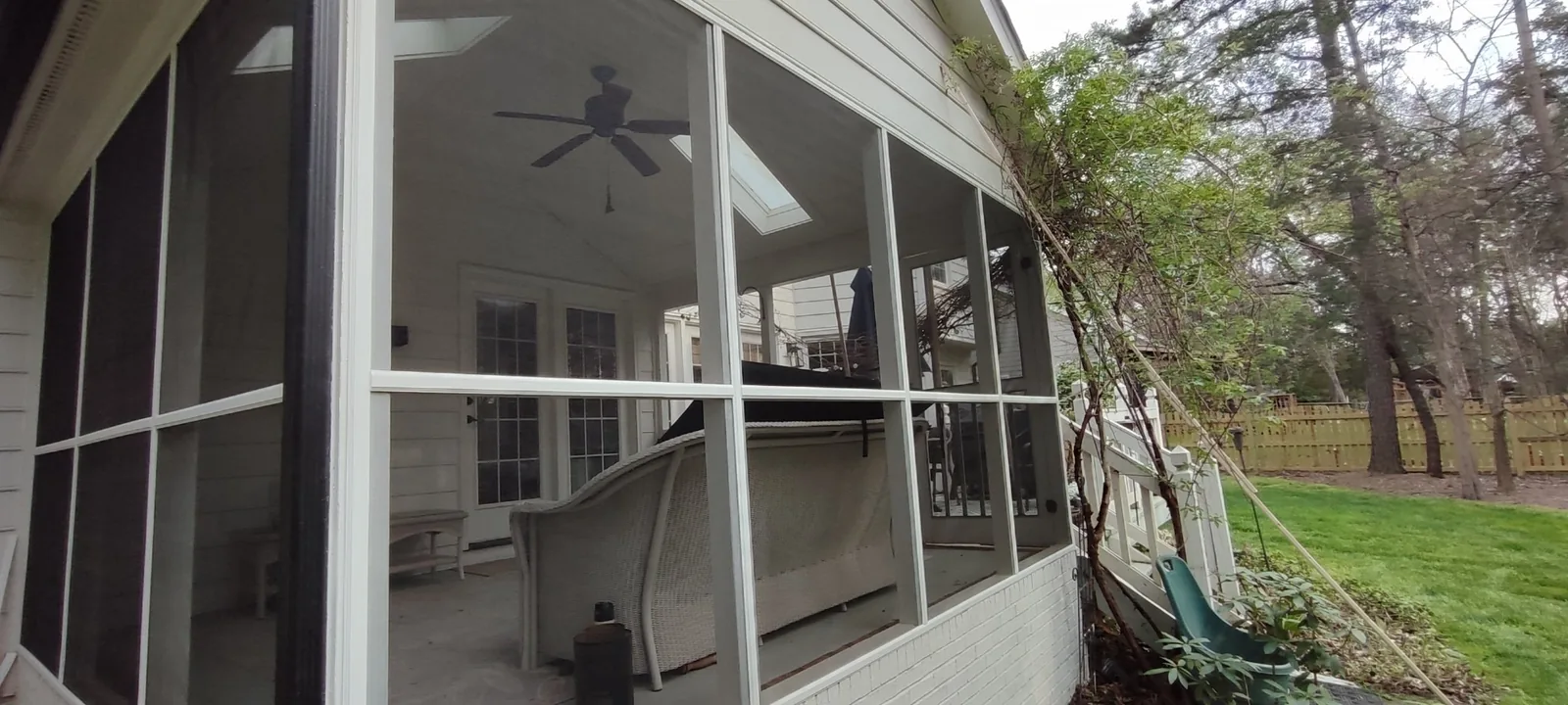 New screen mesh installed across the side panels of the porch