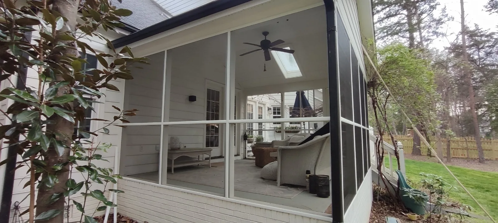 Corner view of newly installed porch screen panels and painted trim