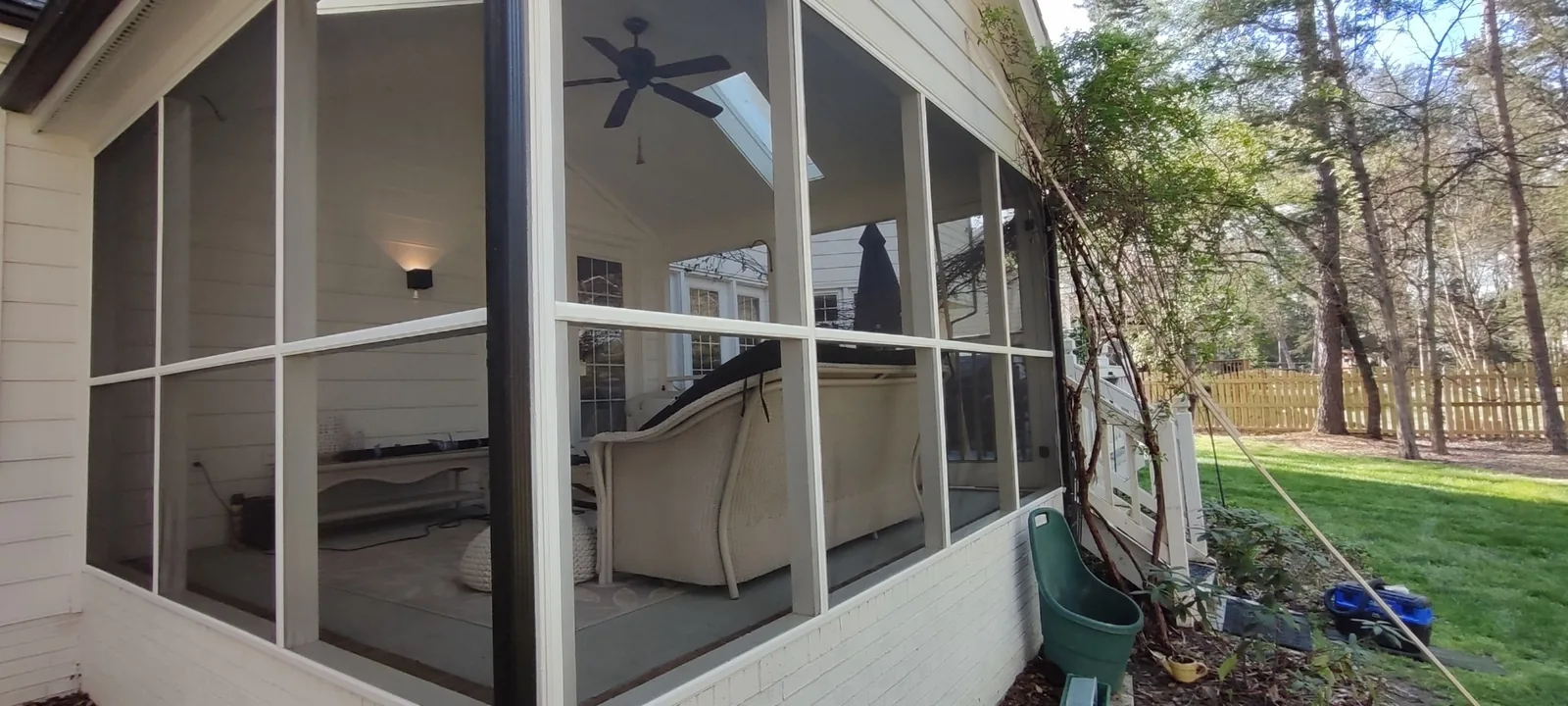 Finished screened porch wall with new mesh secured in the framed openings
