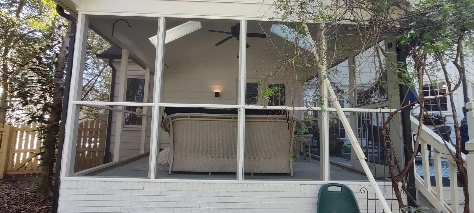 Completed front section of the porch with new screen mesh and clean white trim