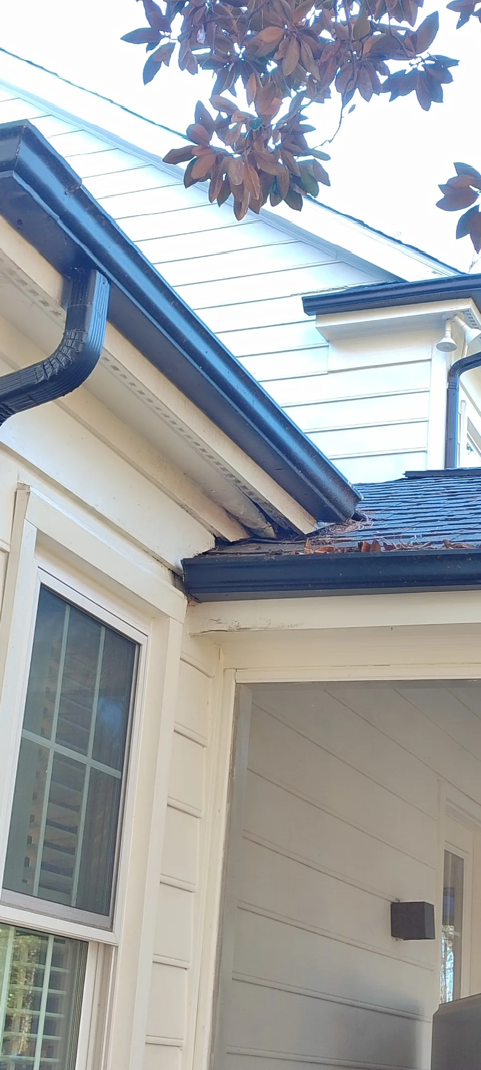 Roof corner with restored soffit and fascia after repair.
