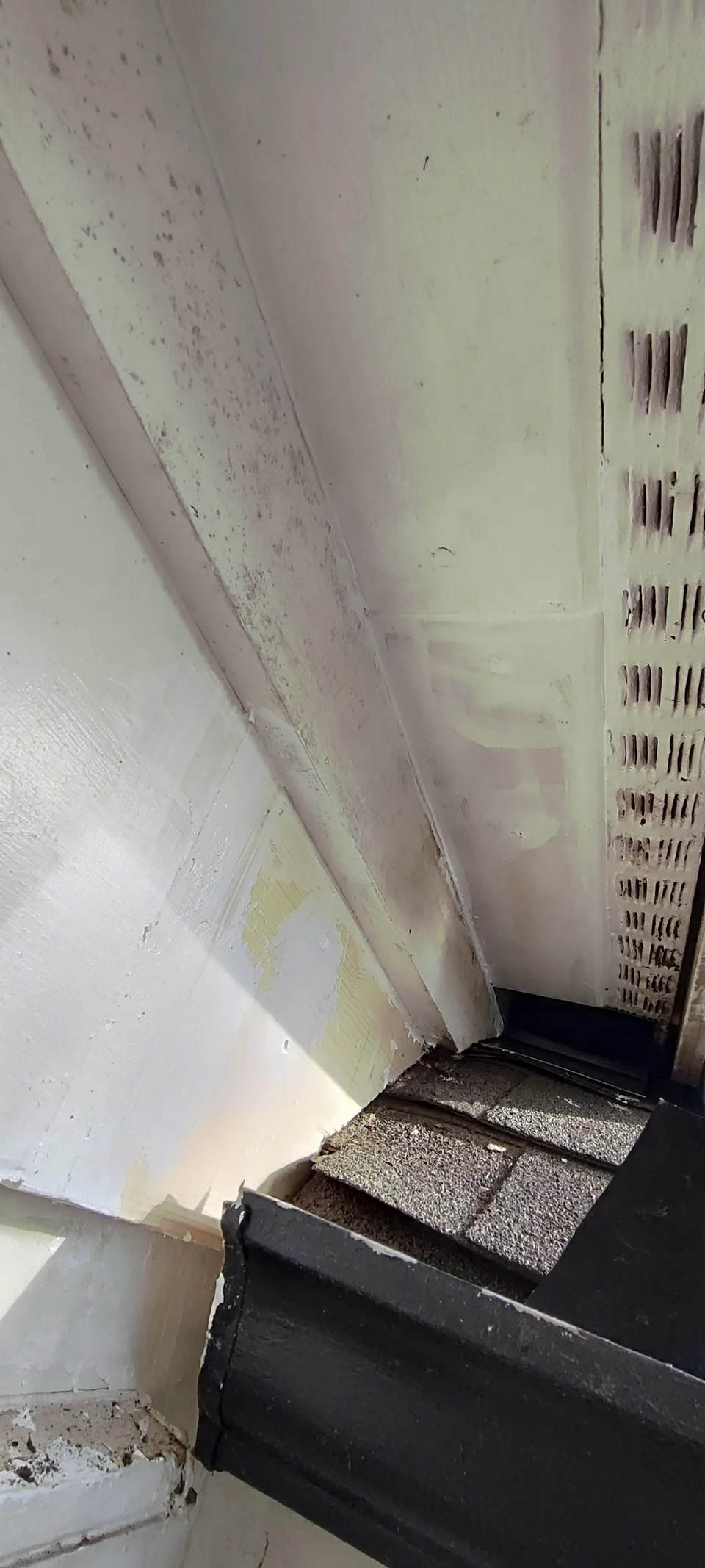 Repaired soffit at the roof corner, viewed from below.
