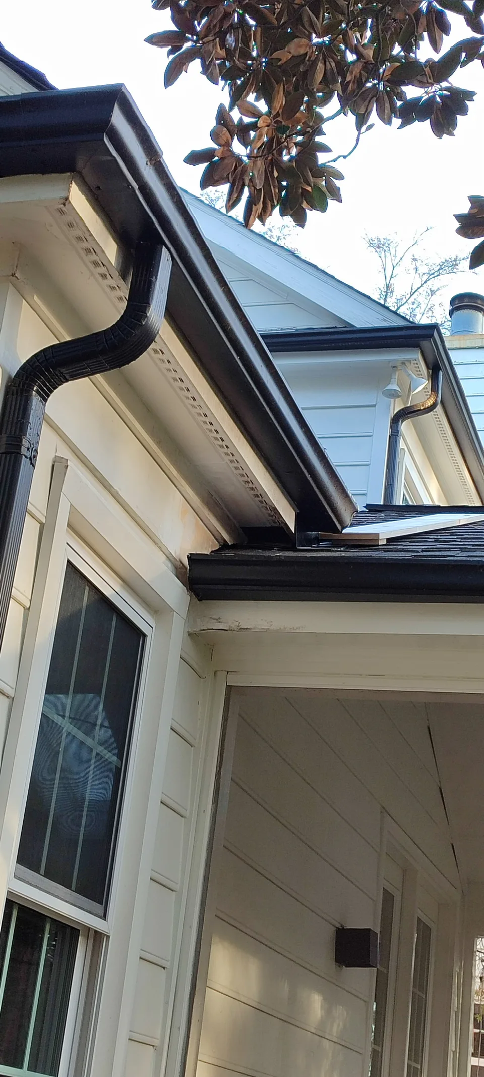 Repaired roof edge with restored exterior trim.