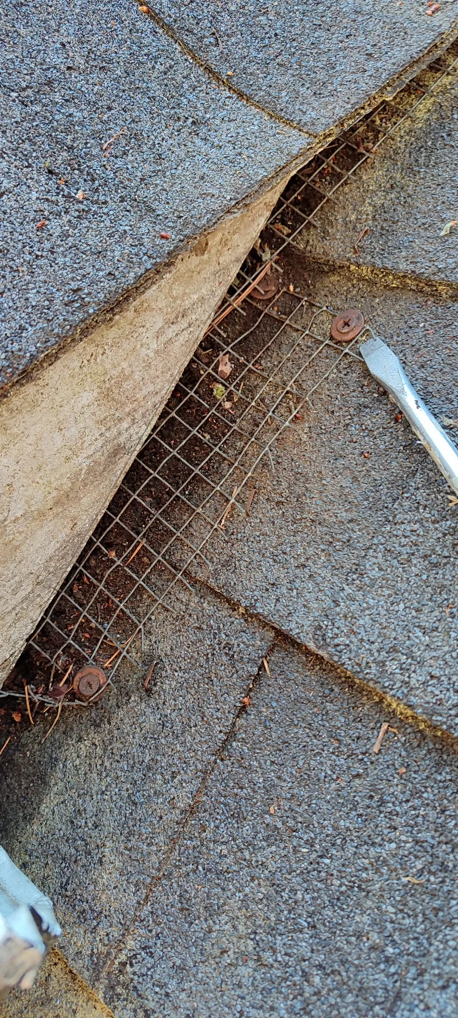 Open area beneath the roof shingles during soffit and fascia repair.