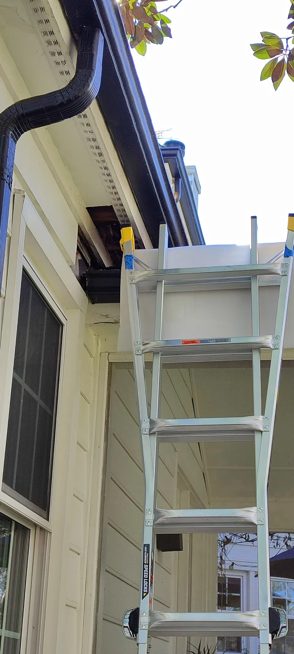 Work area at the roof corner during soffit and fascia repair.