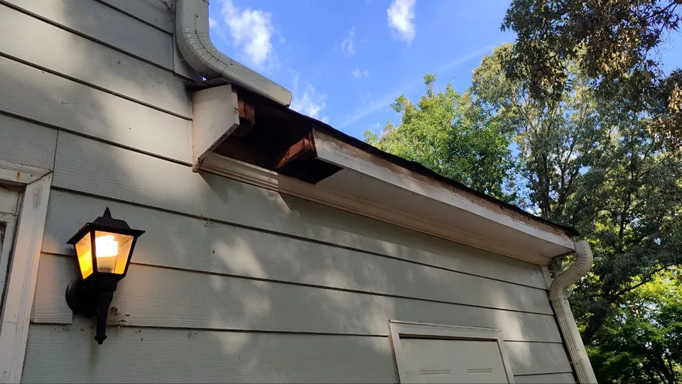 Open roof edge during soffit and fascia repair.