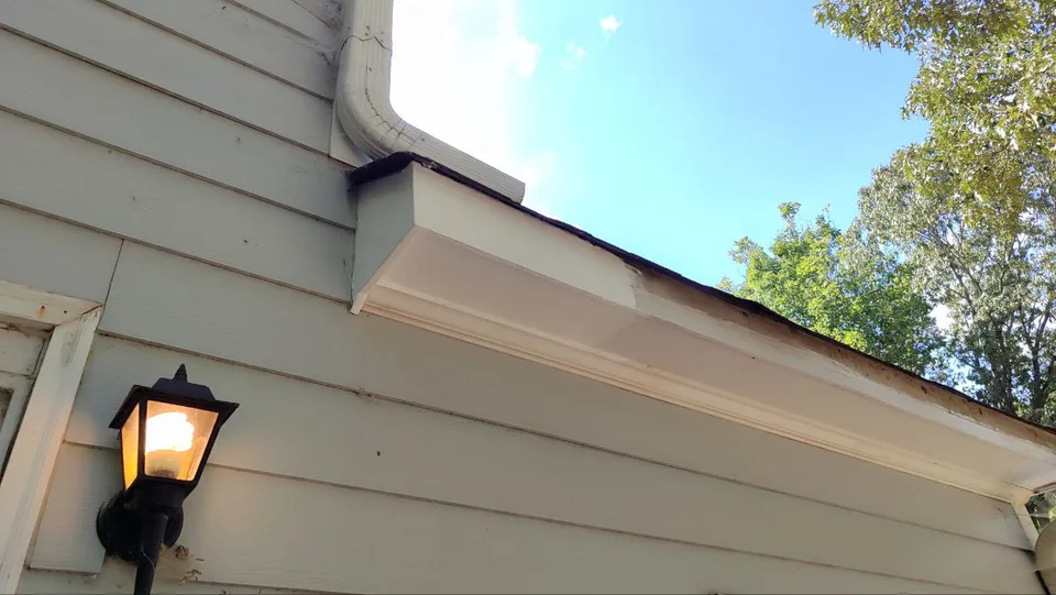 Restored soffit and fascia section at an exterior corner of the house.