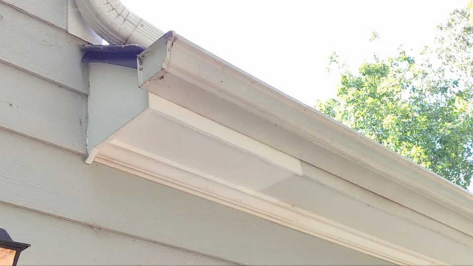 Completed roof edge repair with restored white exterior trim.