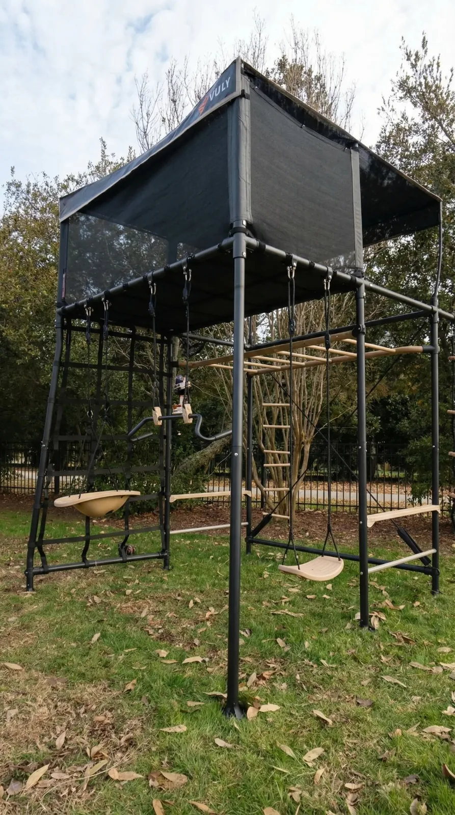 Completed Vuly Quest playset with elevated cubby, swings, climbing elements, and steel frame