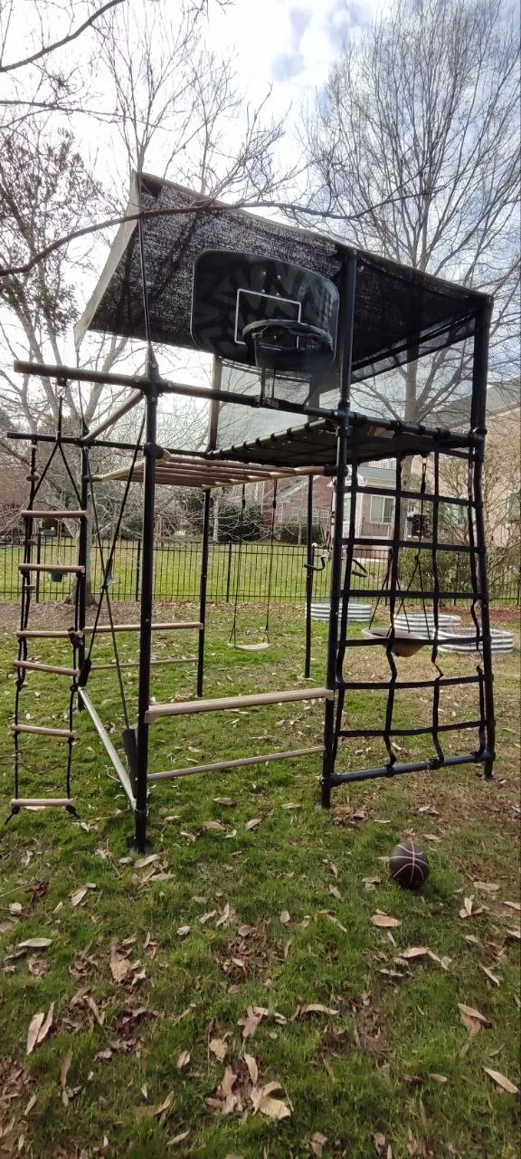 Assembled Vuly Quest playset with basketball hoop and climbing accessories