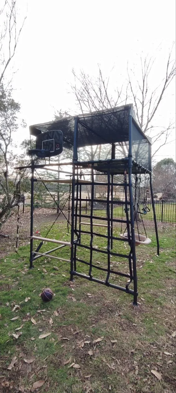 Vuly Quest play structure showing the elevated cubby and surrounding climbing frame