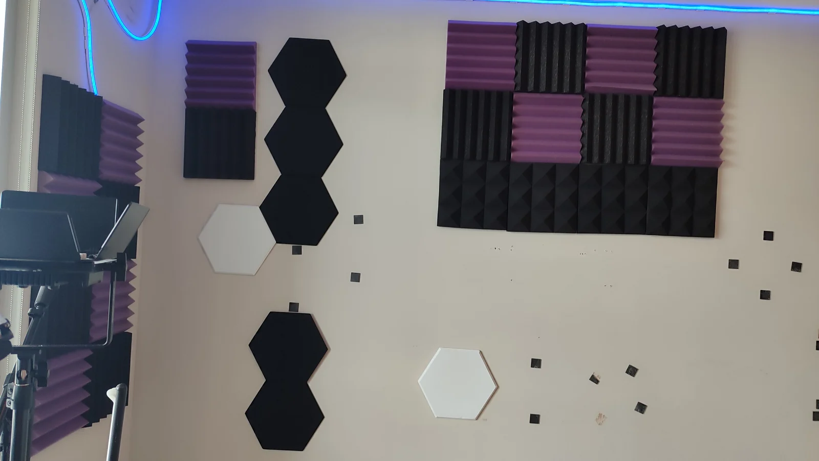 Acoustic panels and mounting marks on the main wall before restoration