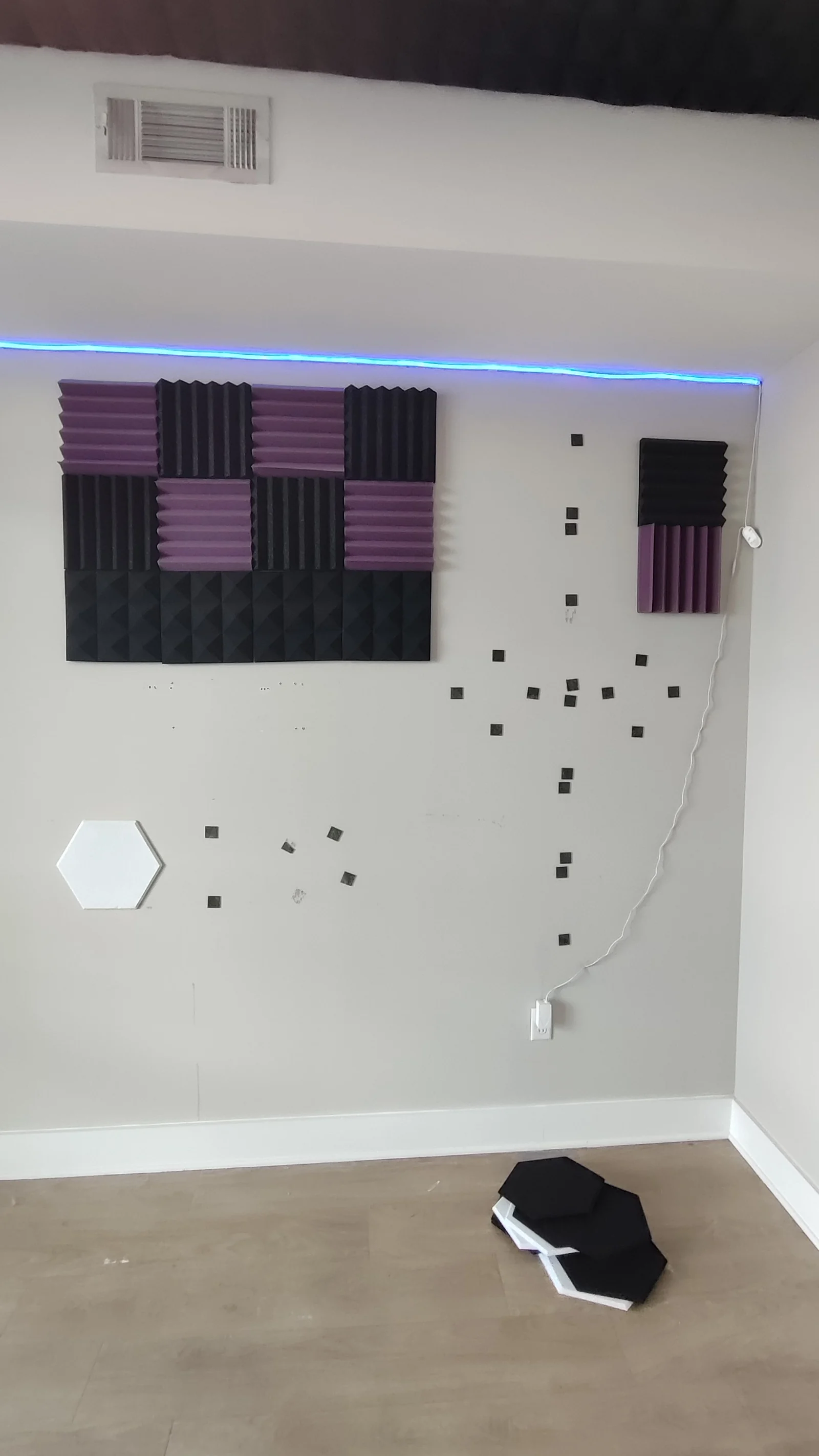 Main wall with acoustic panels beneath the ceiling vent