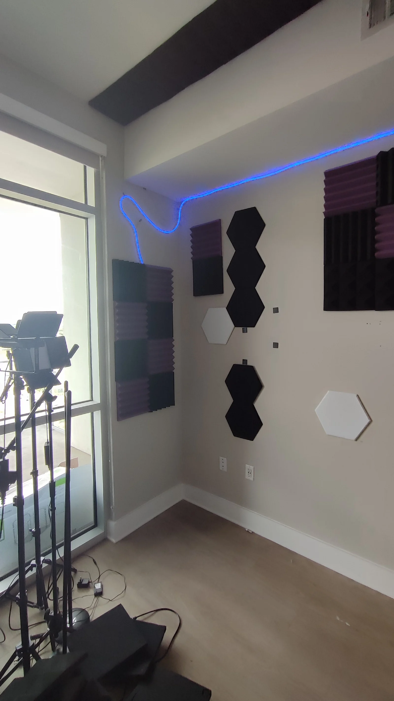 Acoustic panels at the room corner with the window on the left