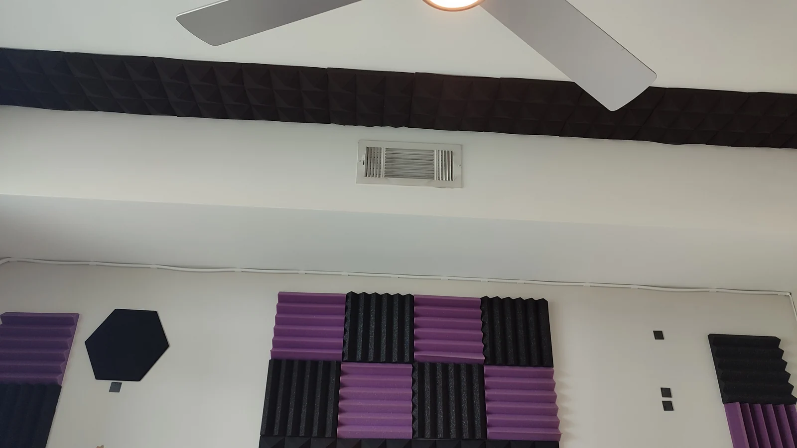 Remaining acoustic panels near the ceiling vent during removal