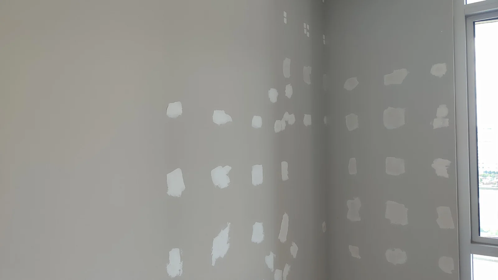 Wall patching at the corner with the window on the right