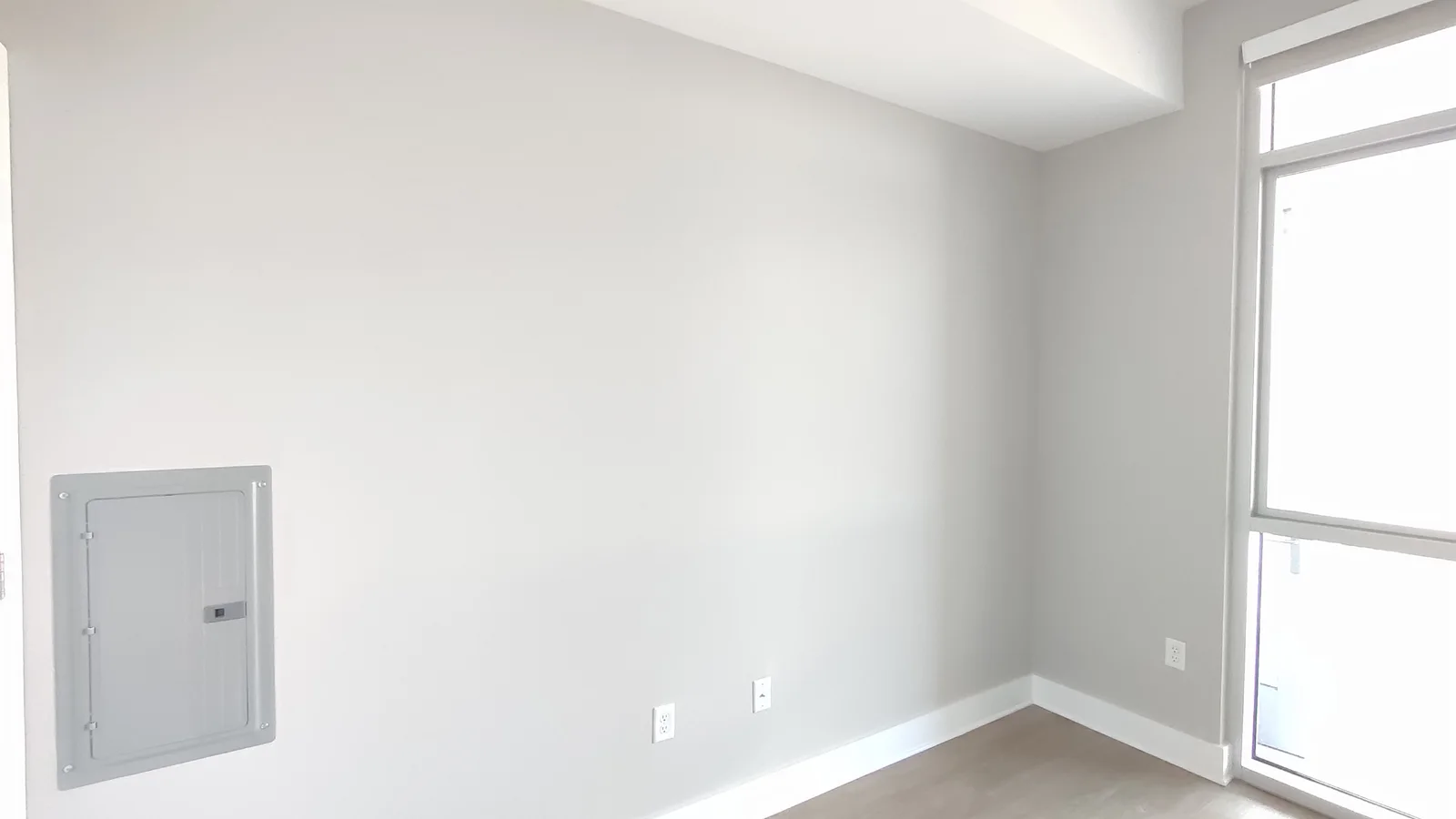 Repainted wall around the electrical panel with the window on the right